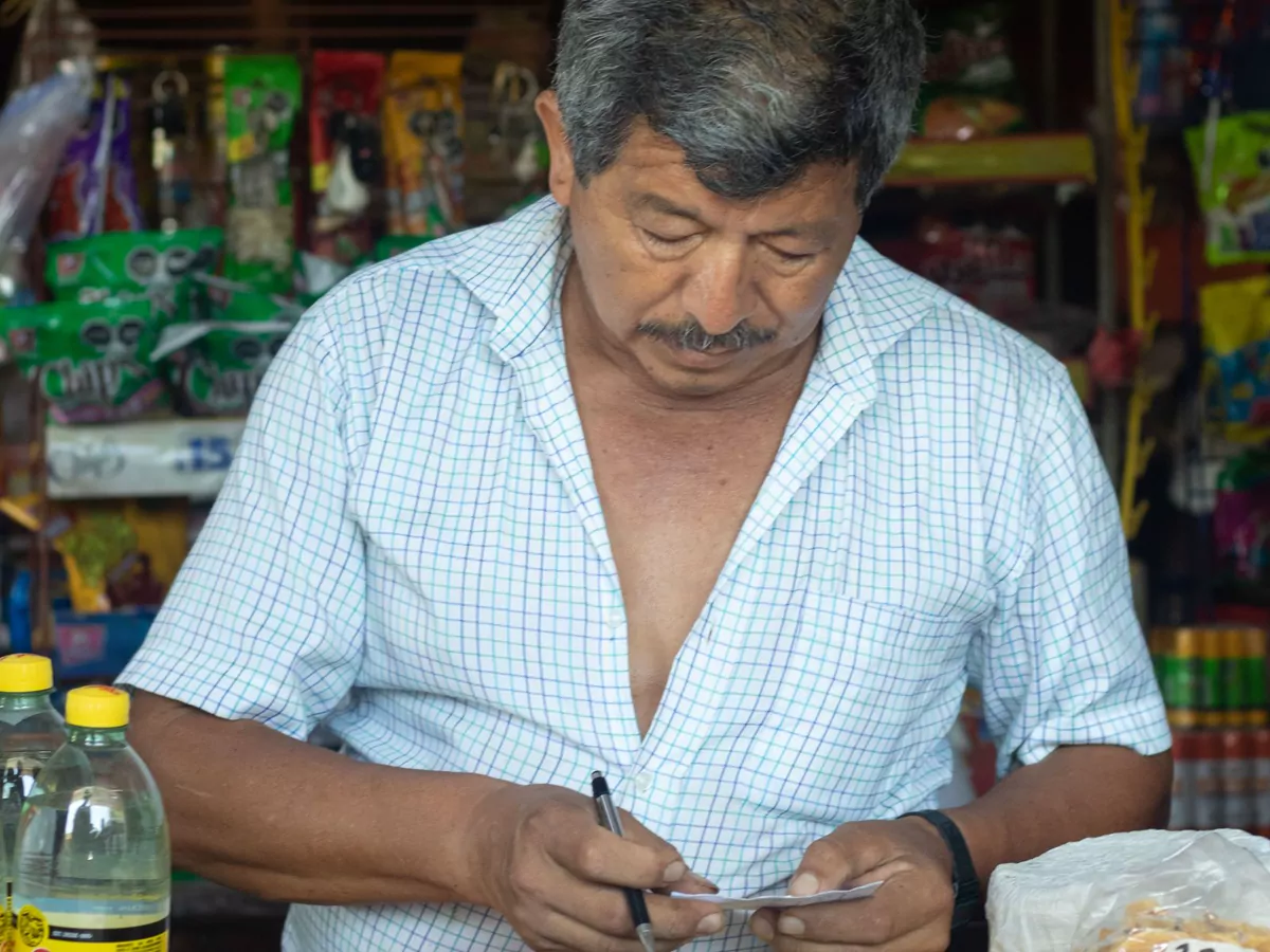 The owner of a corner shop working behind his counter